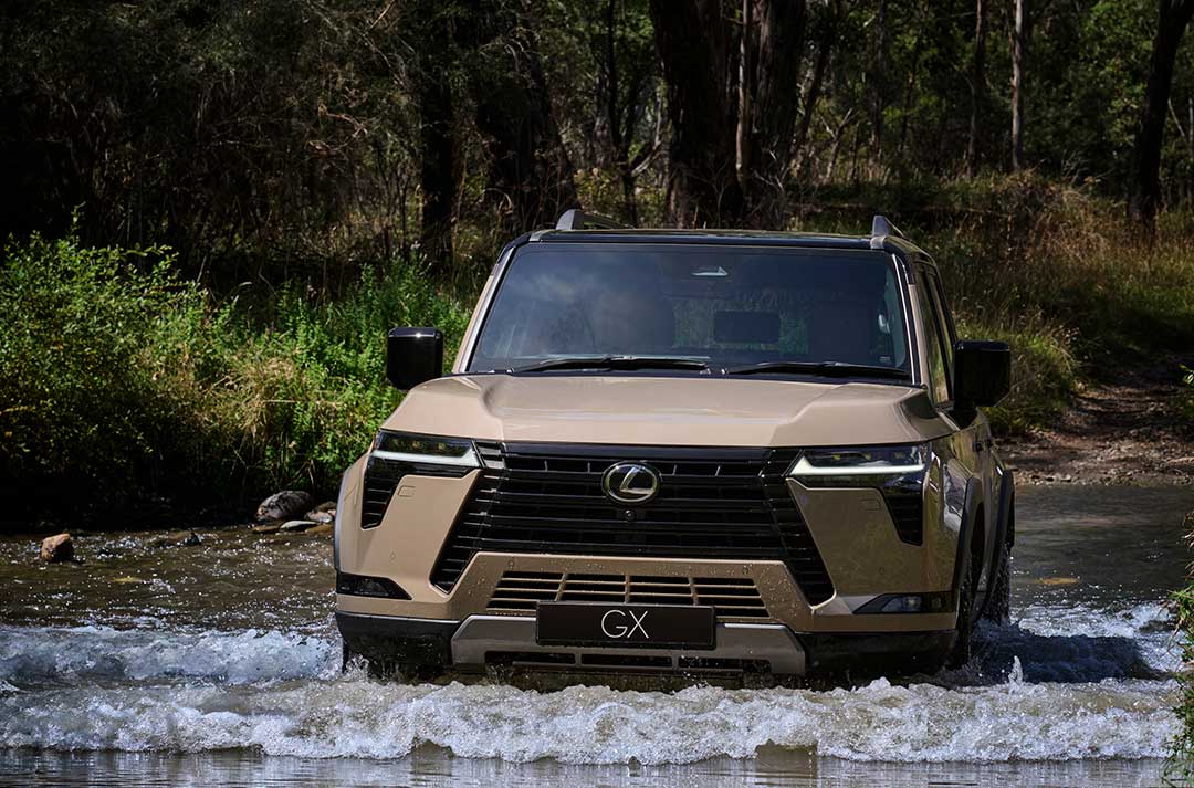 Lexus GX drives through a fresh water crossing.