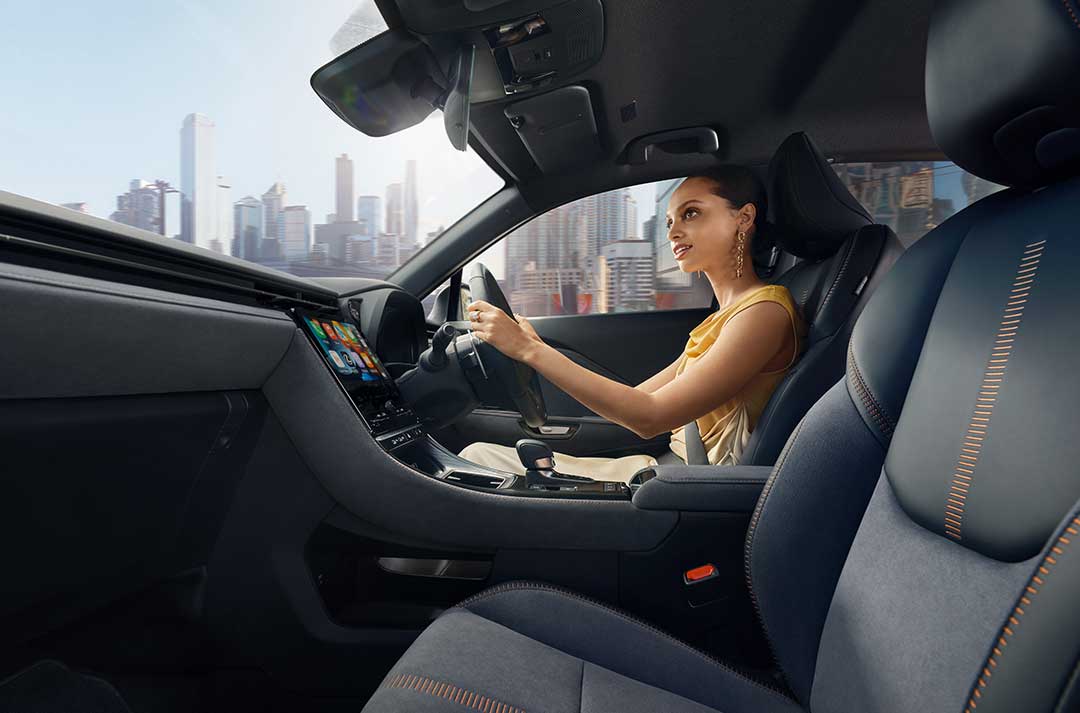 Picture of a woman inside a car, while driving.