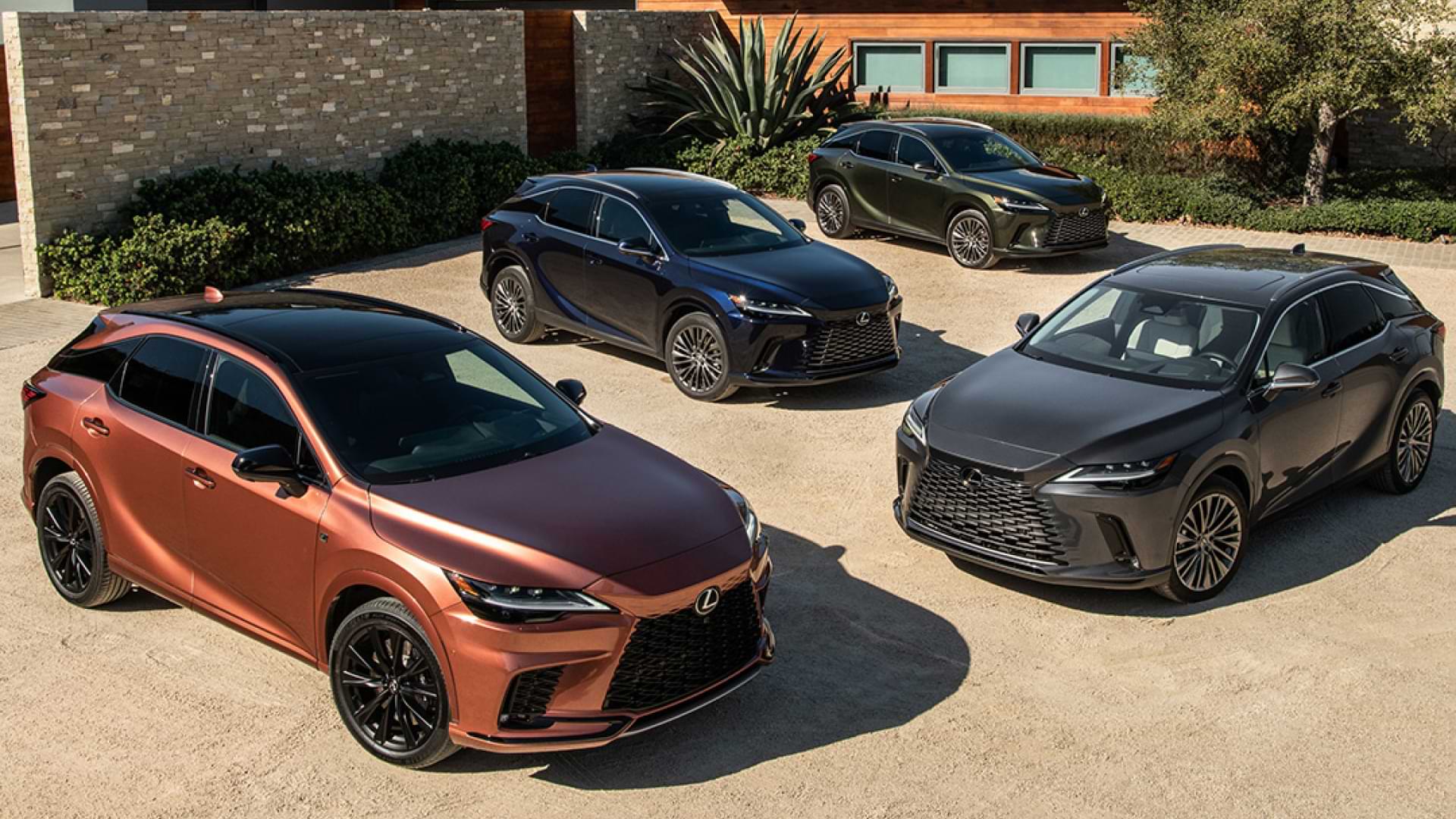 4 differently coloured and equipped RX models are parked in front of a luxury home.