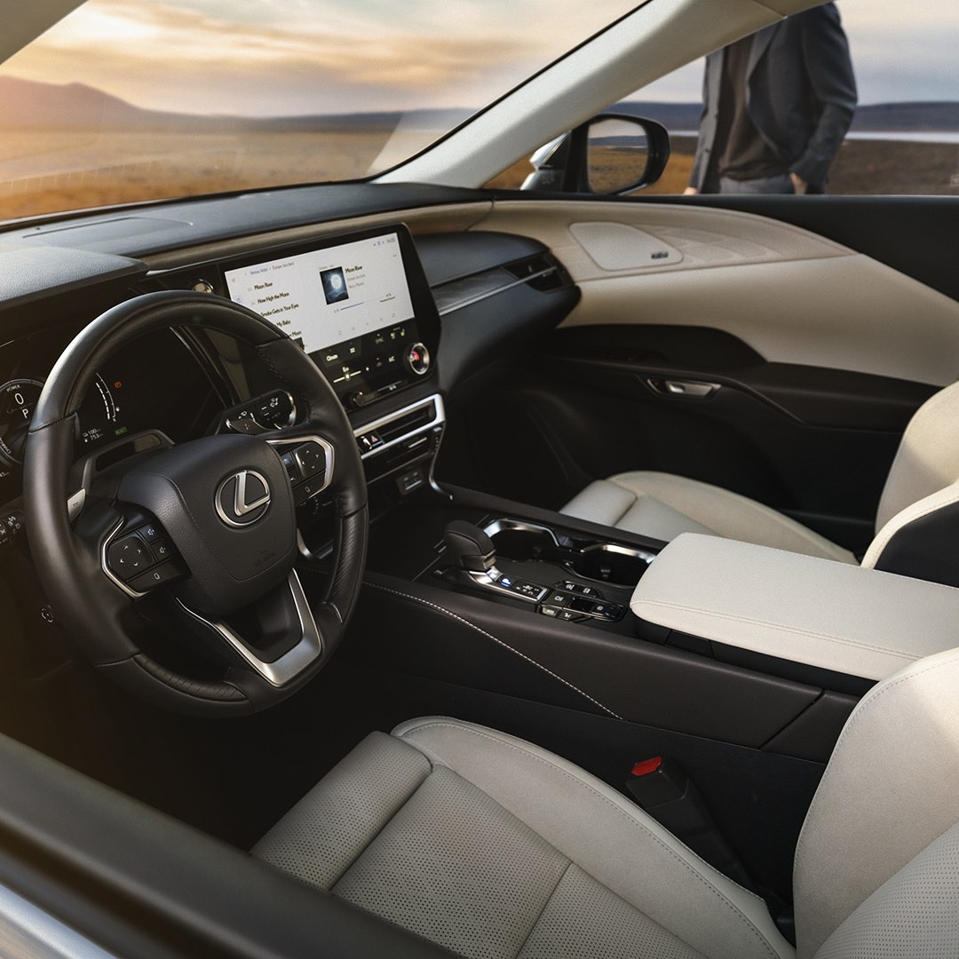 The driver's and front passenger's seat of the new RX. The interior multimedia screen is alight.