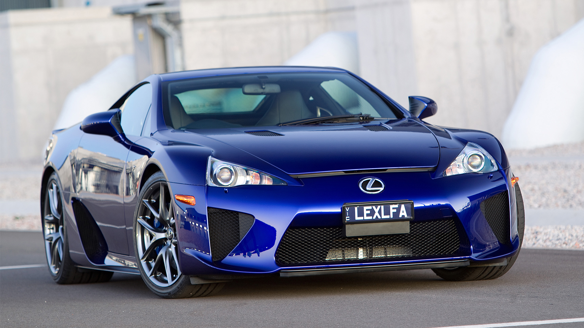 Vibrant blue Lexus LFA sports car parked outdoors, featuring black grille.
