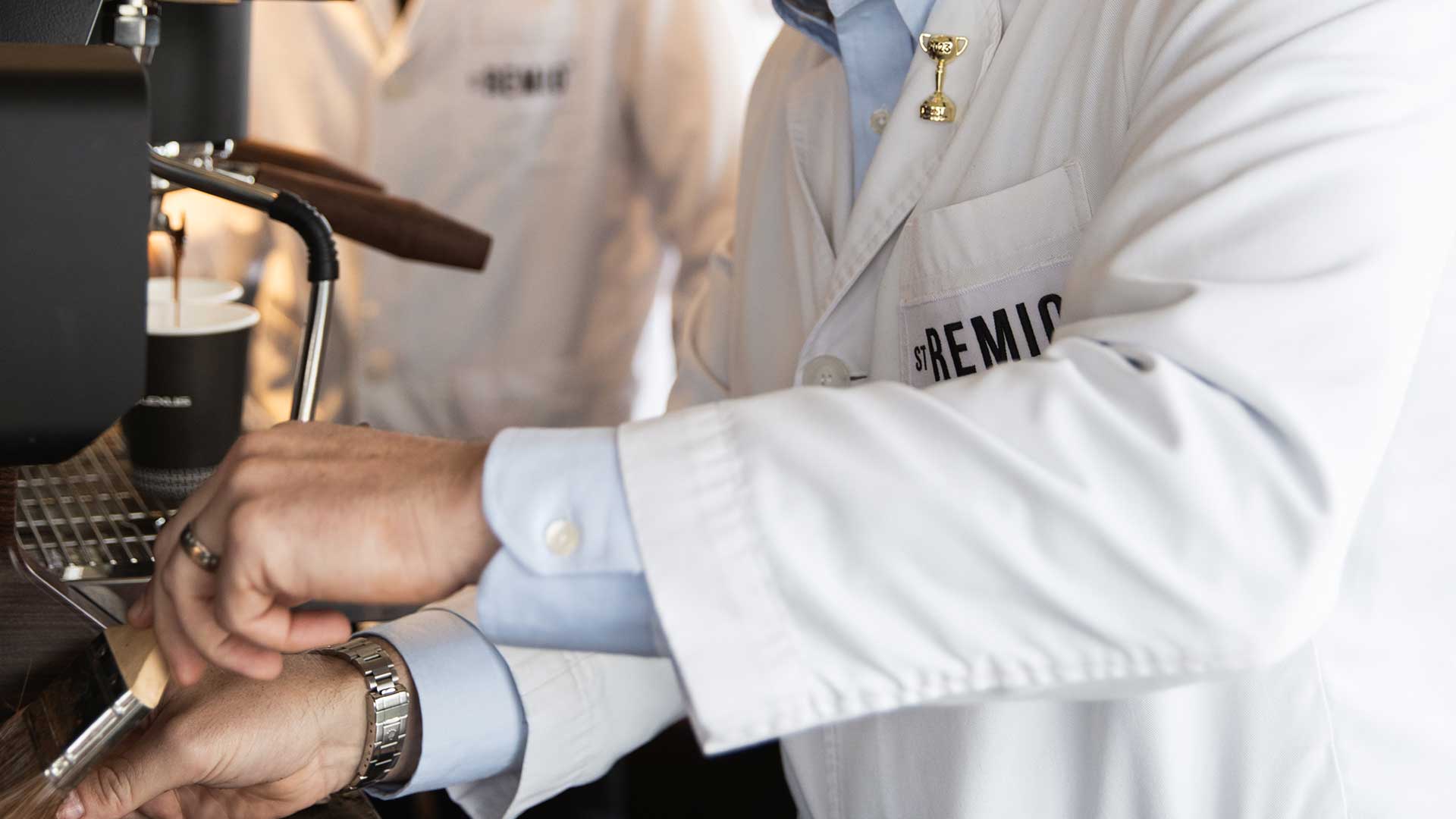 A barista makes a coffee with the Lexus St Remio coffee beans