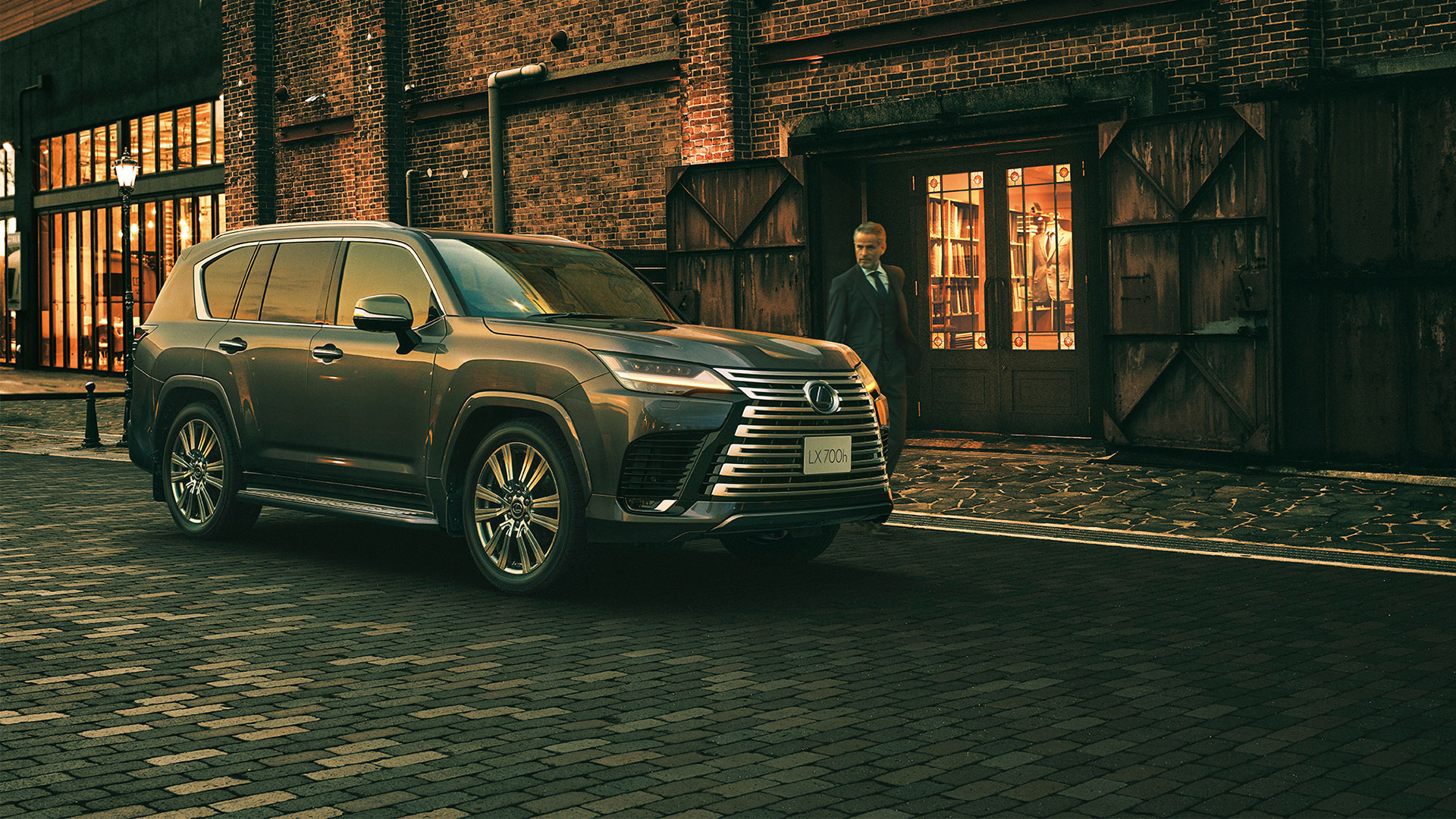 Khaki Metal Lexus LX Overtrail parked outside building at night.