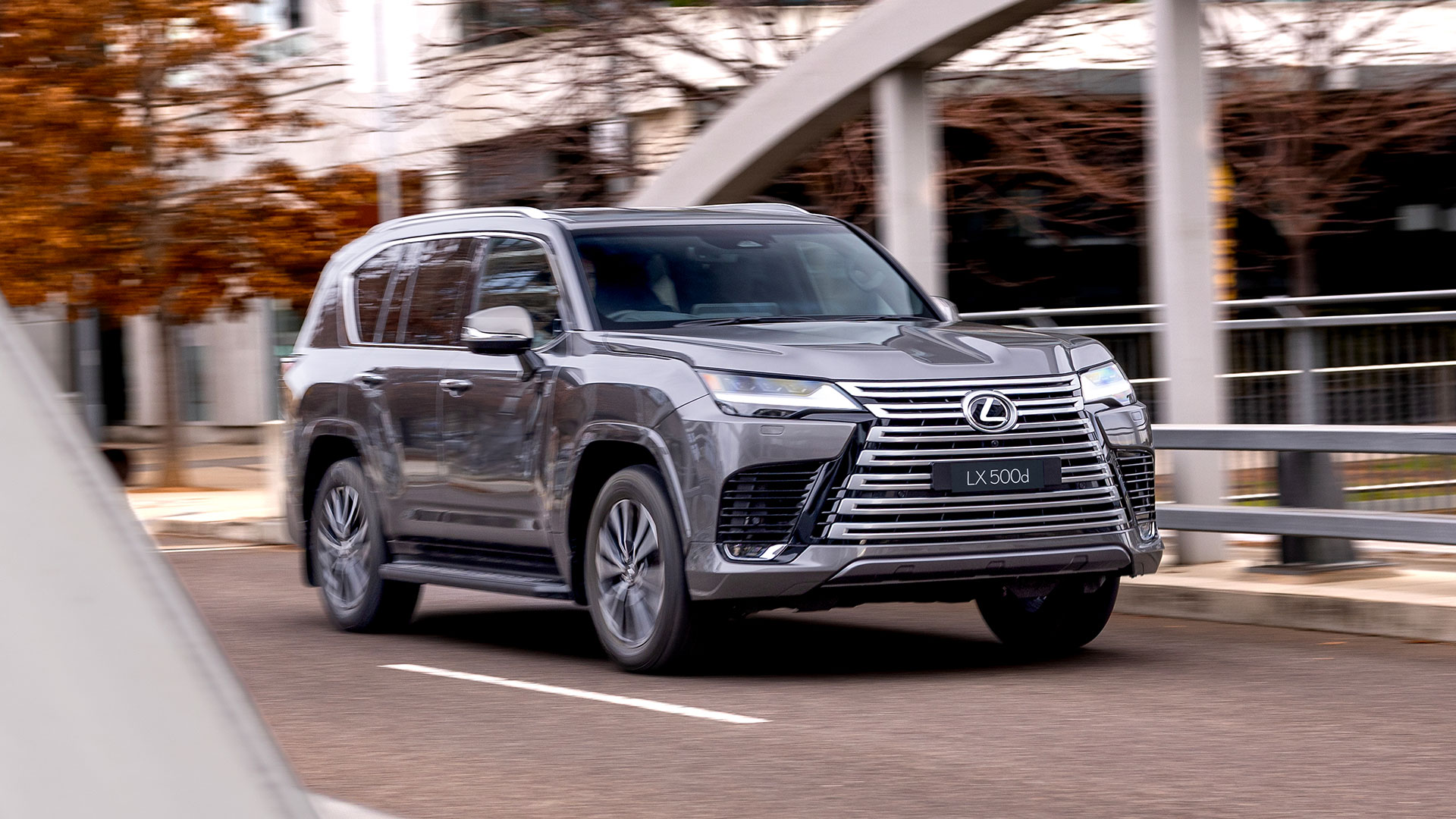 Grey 2025 Lexus LX 500d Luxury driving along a residential road 